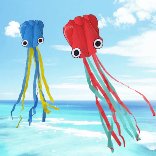 Wikz Blæksprutte drager i blå og rød, vist ved havet
